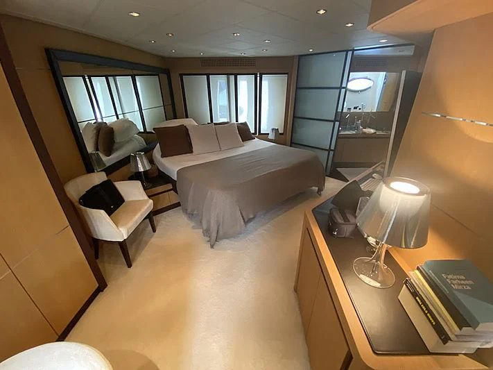a hotel room with a bed and a lamp aboard MM Yacht for Sale