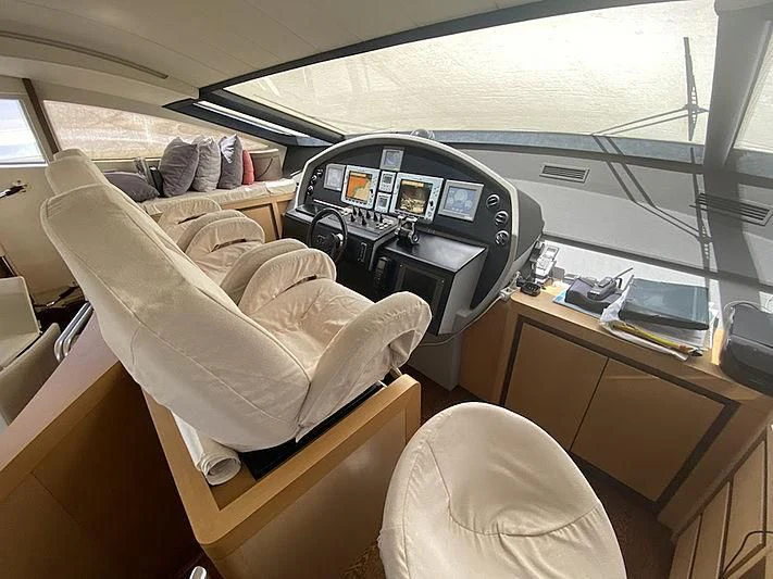 inside of a vehicle with a seat and a desk with a computer and a chair aboard MM Yacht for Sale