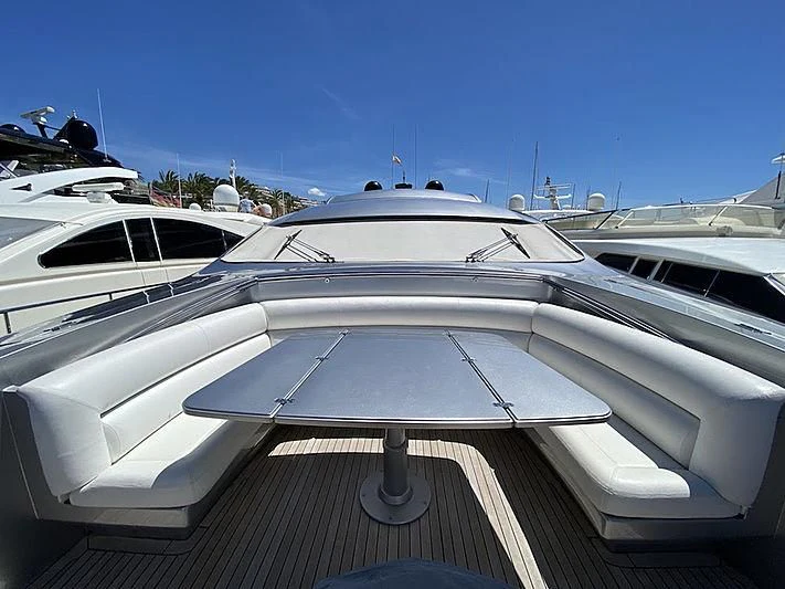 a white yacht with a black and white striped roof aboard MM Yacht for Sale