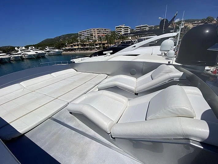 a white boat on a deck aboard MM Yacht for Sale