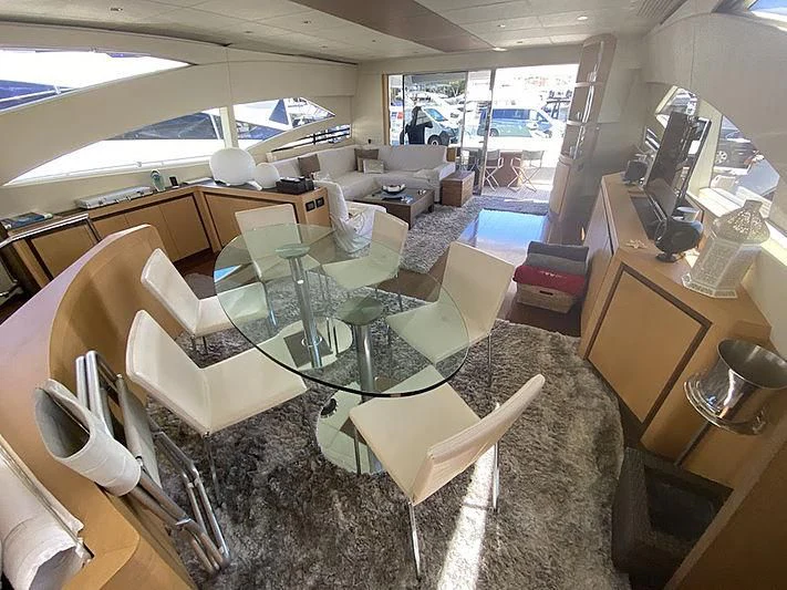 a room with a table chairs and a large window aboard MM Yacht for Sale