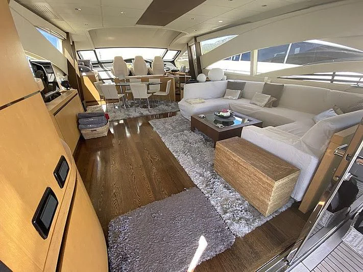 a room with a couch and a table aboard MM Yacht for Sale