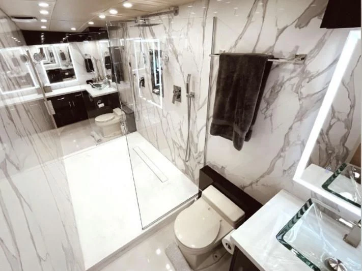 a bathroom with a toilet and bathtub aboard SOVEREIGN LADY Yacht for Sale