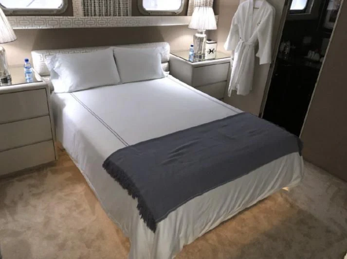 a bed with white sheets aboard SOVEREIGN LADY Yacht for Sale