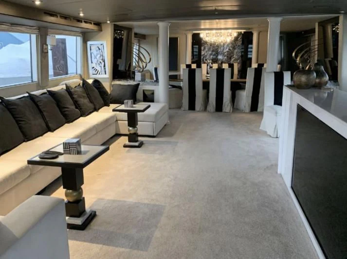 a living room with a couch and a coffee table aboard SOVEREIGN LADY Yacht for Sale