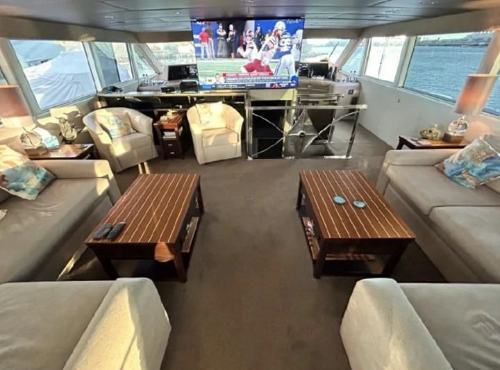 a living room with a large window aboard SOVEREIGN LADY Yacht for Sale