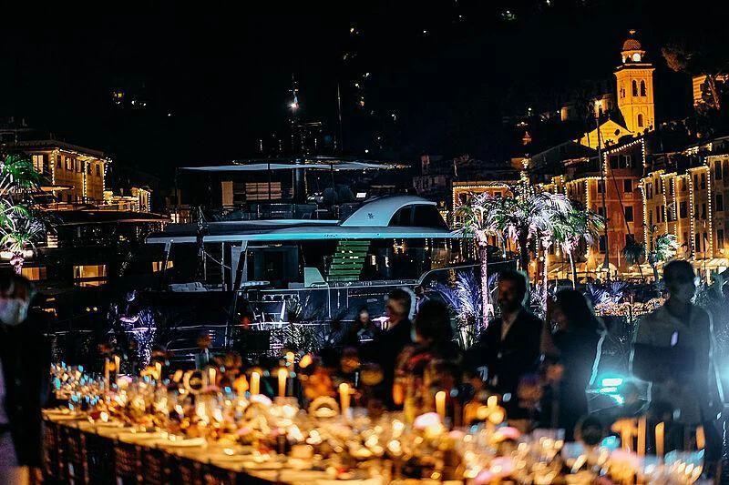 a crowd of people around a city aboard JAKAT Yacht for Sale