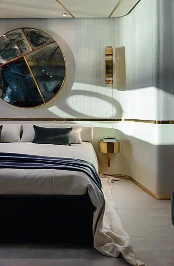 a bed with a blue sheet aboard JAKAT Yacht for Sale