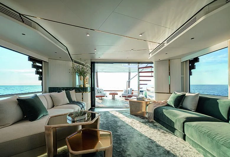 a living room with a couch and a table aboard JAKAT Yacht for Sale