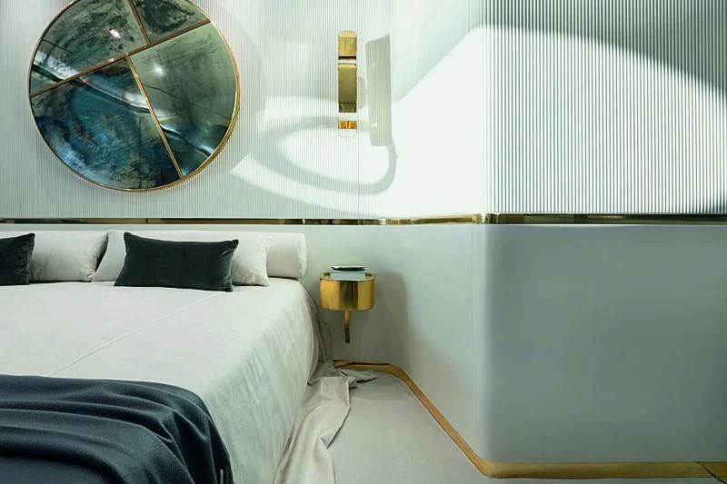 a bed with a mirror above it aboard JAKAT Yacht for Sale