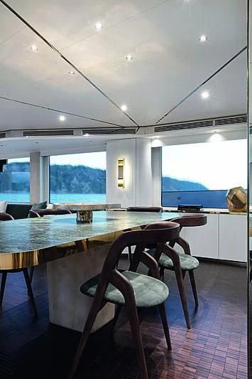 a room with a table and chairs aboard JAKAT Yacht for Sale
