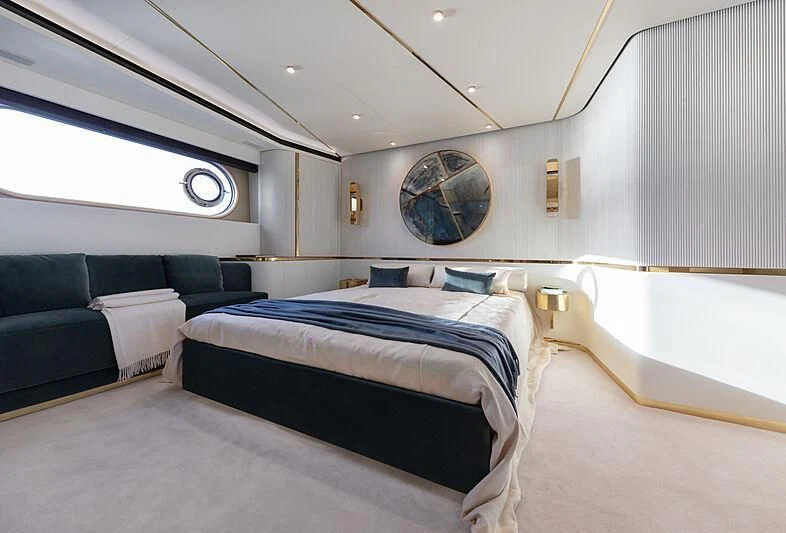 a room with a bed and a couch aboard JAKAT Yacht for Sale