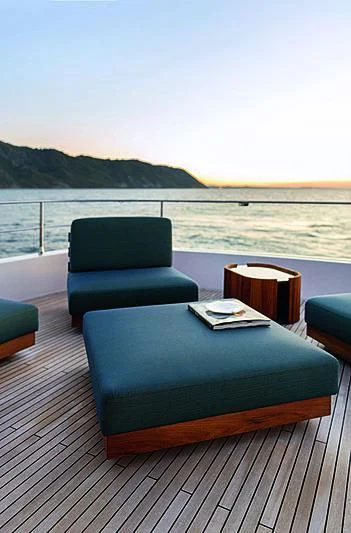 a table on a deck overlooking a body of water aboard JAKAT Yacht for Sale