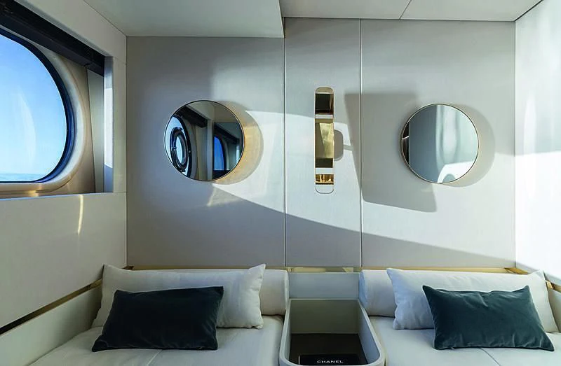 a room with a bed and a mirror aboard JAKAT Yacht for Sale