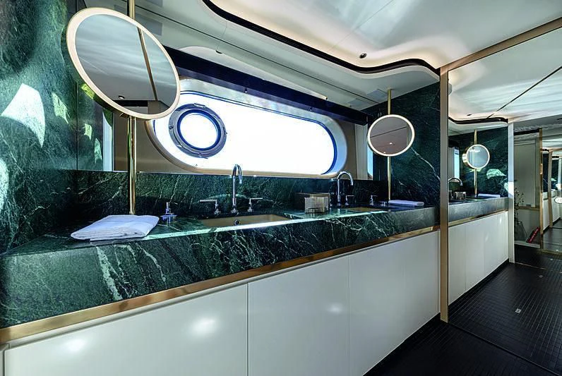a bathroom with a large mirror aboard JAKAT Yacht for Sale