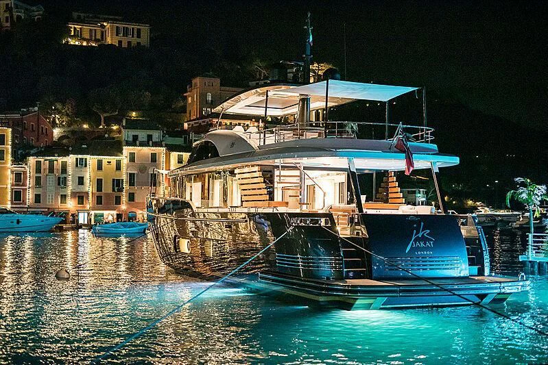 a boat docked at night aboard JAKAT Yacht for Sale