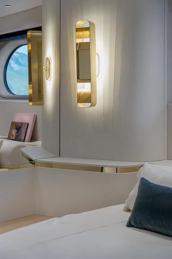 a bed with a mirror above it aboard JAKAT Yacht for Sale