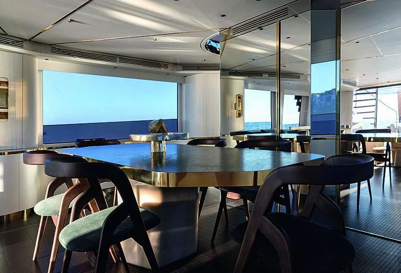 a room with a table and chairs aboard JAKAT Yacht for Sale