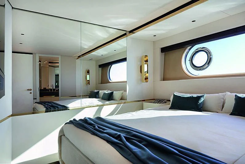 a room with a bed and a window aboard JAKAT Yacht for Sale