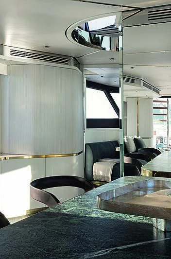 a train with a table and chairs aboard JAKAT Yacht for Sale