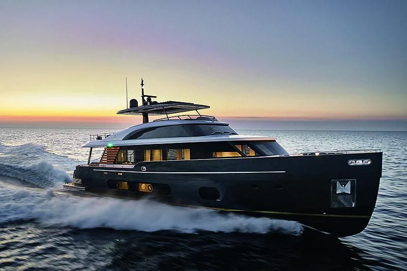 a black boat on water aboard JAKAT Yacht for Sale