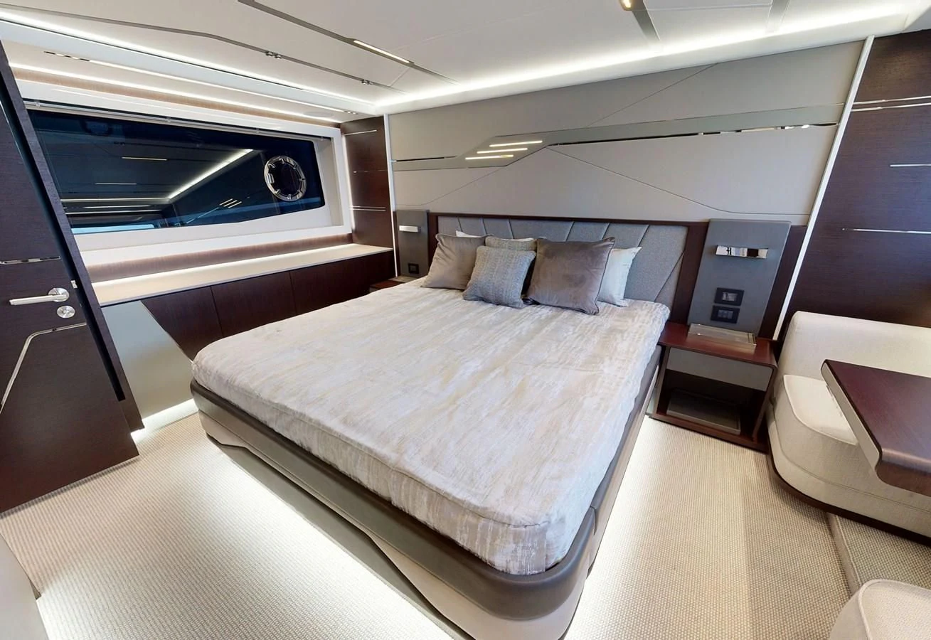 a room with a bed and a couch aboard FIVE II Yacht for Sale