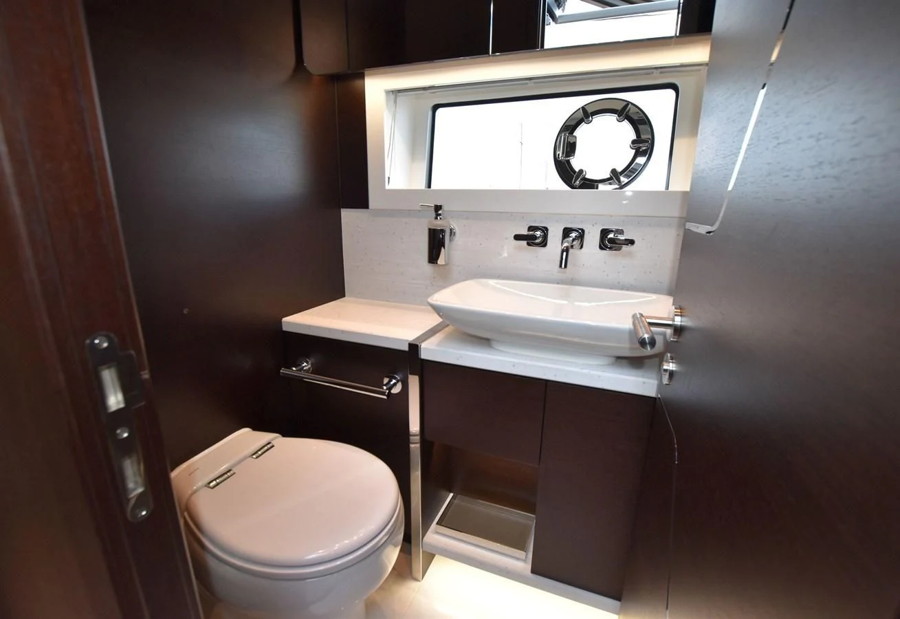 a bathroom with a sink and toilet aboard FIVE II Yacht for Sale
