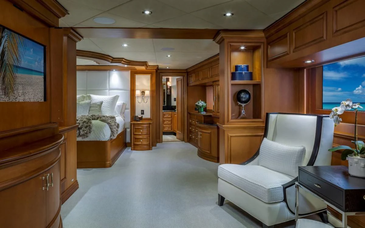 a room with a bed and a chair aboard M3 Yacht for Sale