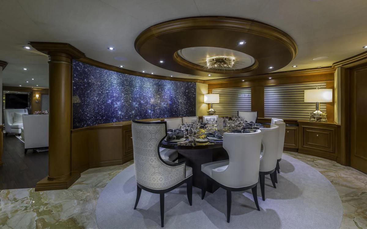 a large room with a table and chairs aboard M3 Yacht for Sale