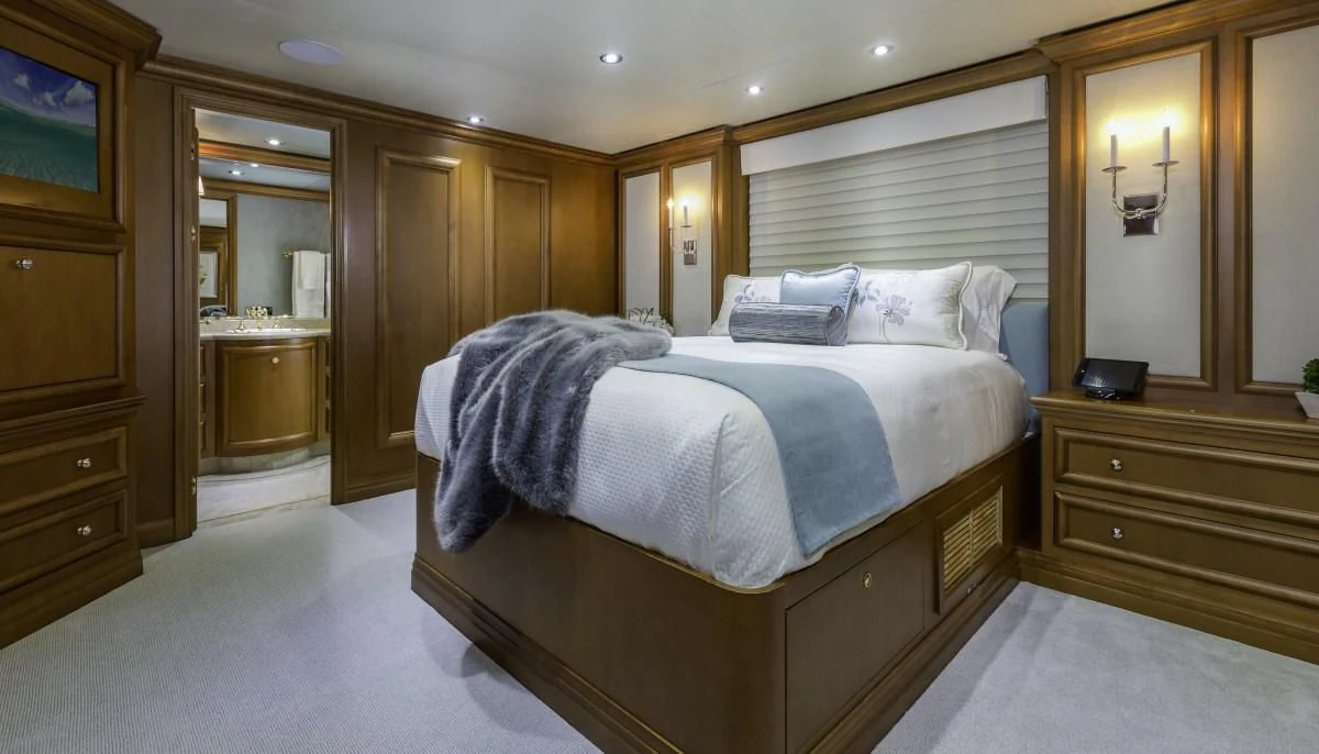 a bedroom with a bed and a desk aboard M3 Yacht for Sale