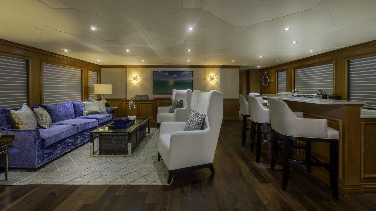 a living room with a couch and a table aboard M3 Yacht for Sale