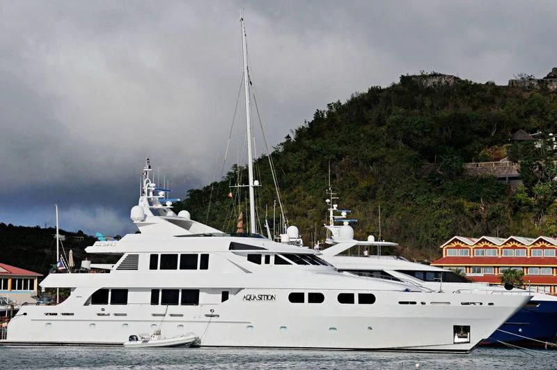 a white boat in a harbor aboard M3 Yacht for Sale