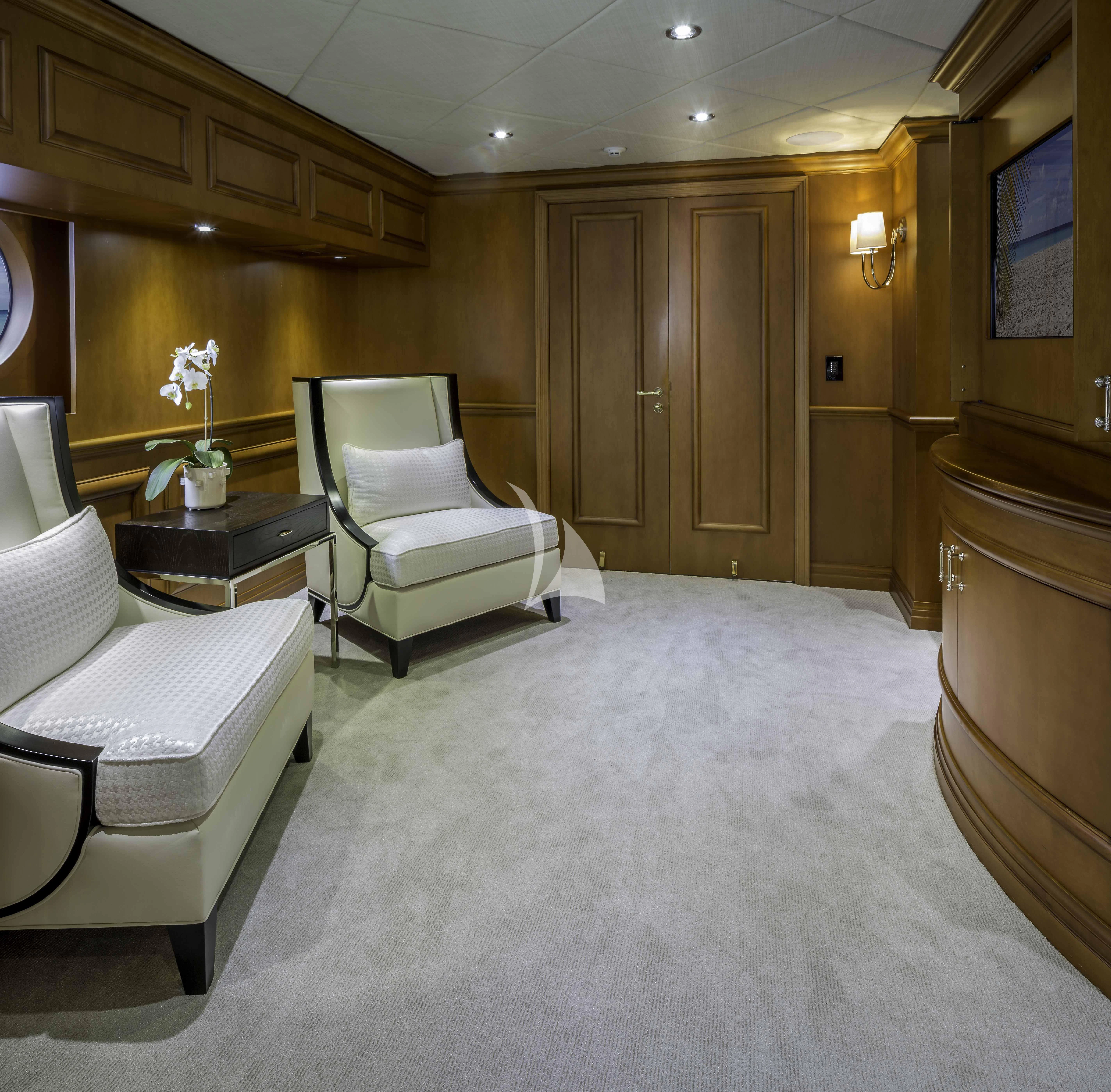 a room with a couple of white chairs and a table aboard M3 Yacht for Sale
