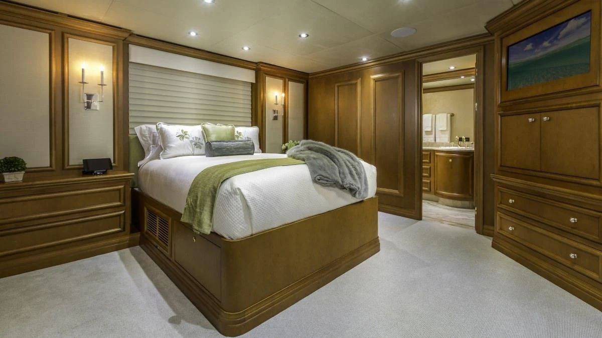 a large bedroom with a bed aboard M3 Yacht for Sale