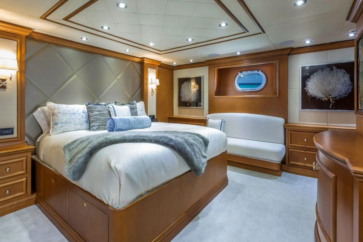 a bedroom with a bed and a desk aboard M3 Yacht for Sale