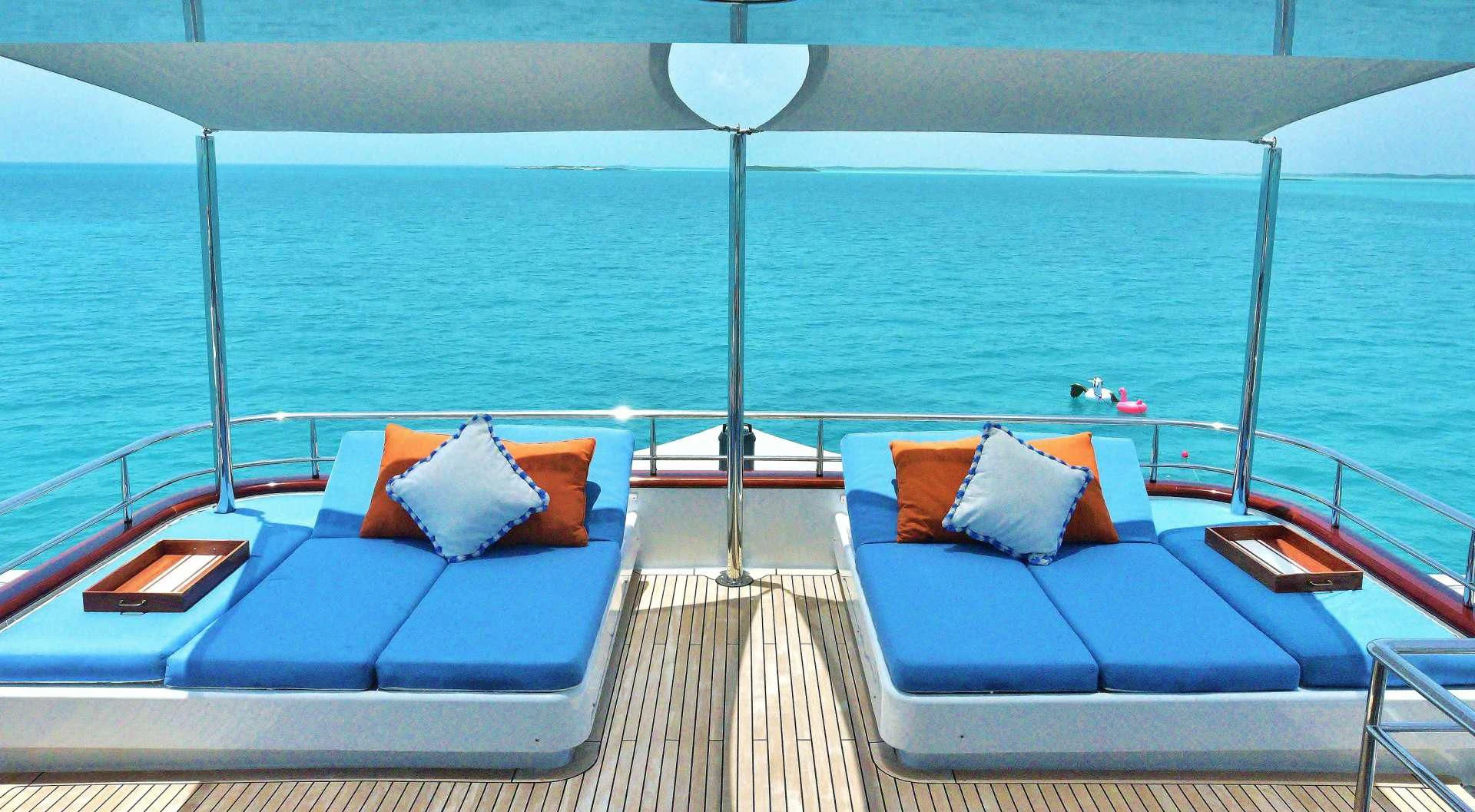a deck with a couch and a lamp on it aboard M3 Yacht for Sale