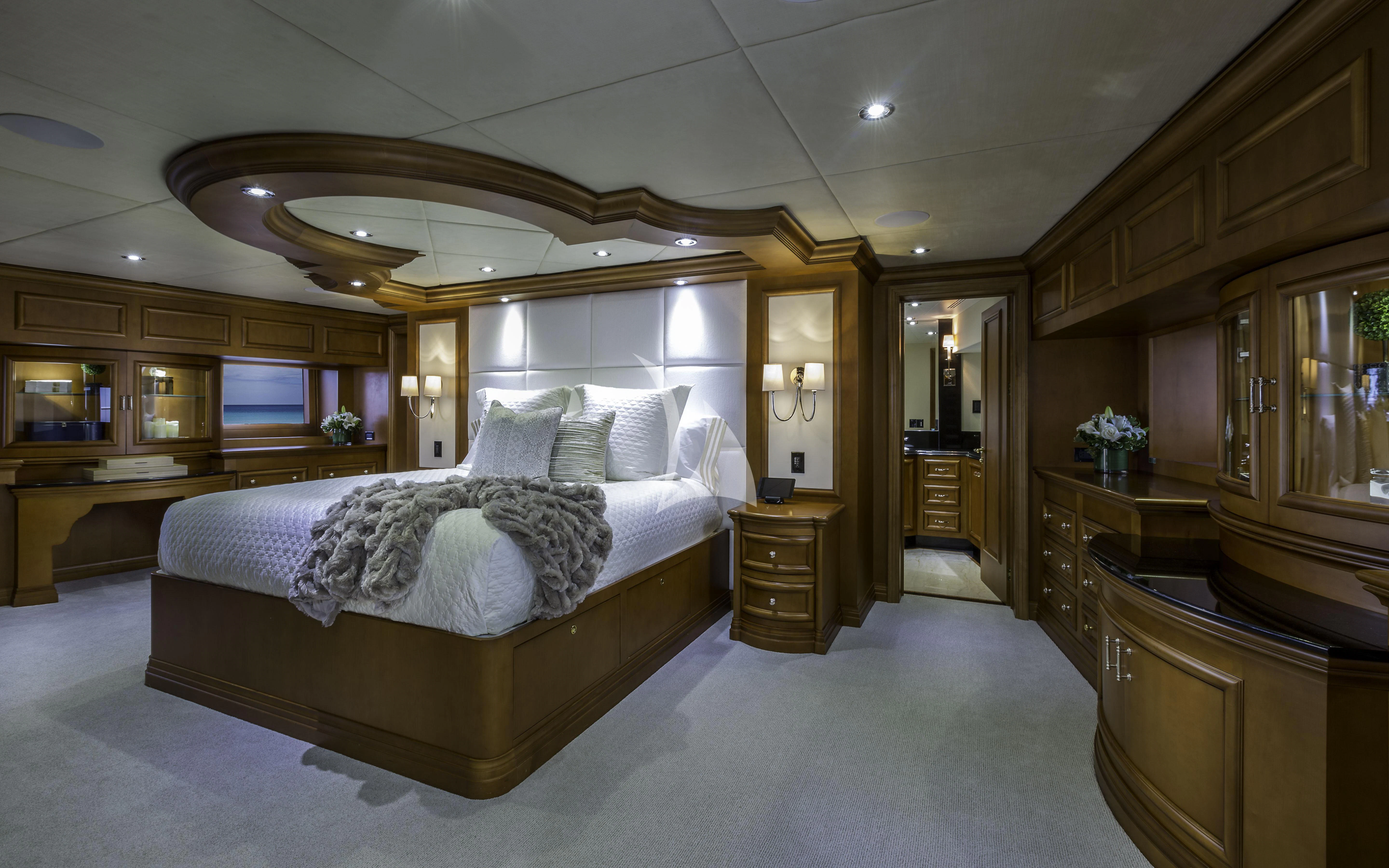 a large bedroom with a large bed aboard M3 Yacht for Sale