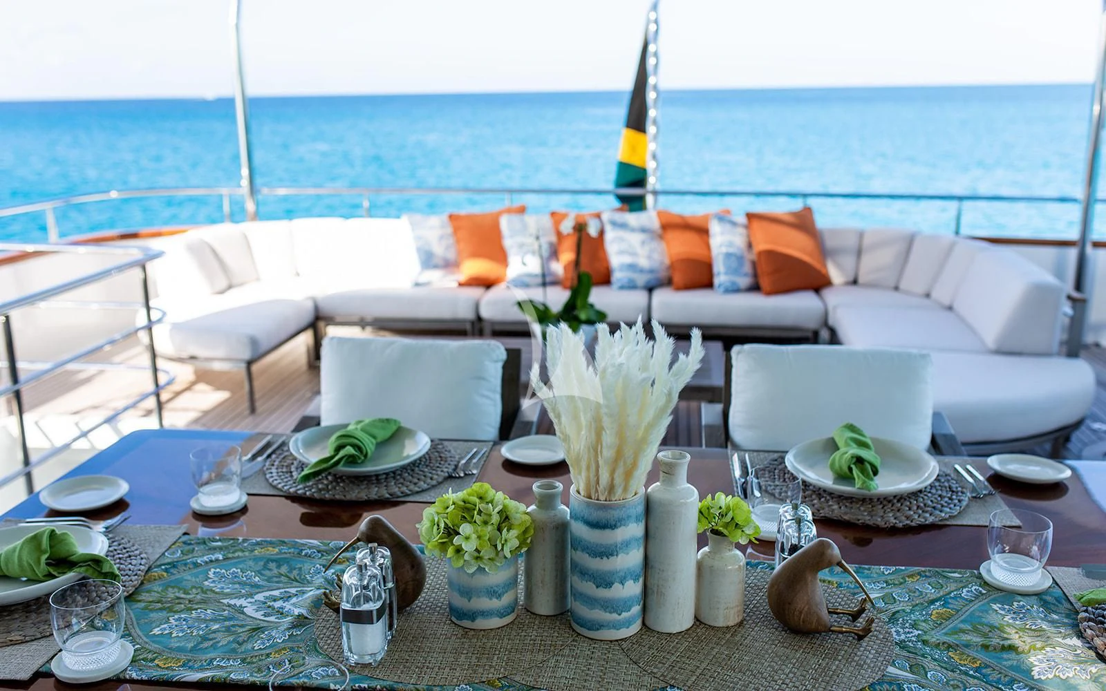 a table with plates and flowers on it aboard M3 Yacht for Sale