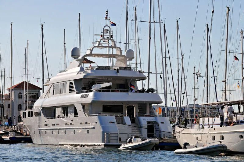 a large white boat with a couple of people on it aboard M3 Yacht for Sale