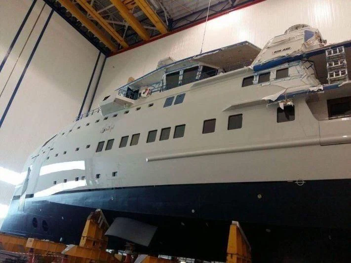 a large white and blue ship aboard UM ALHOUL Yacht for Sale