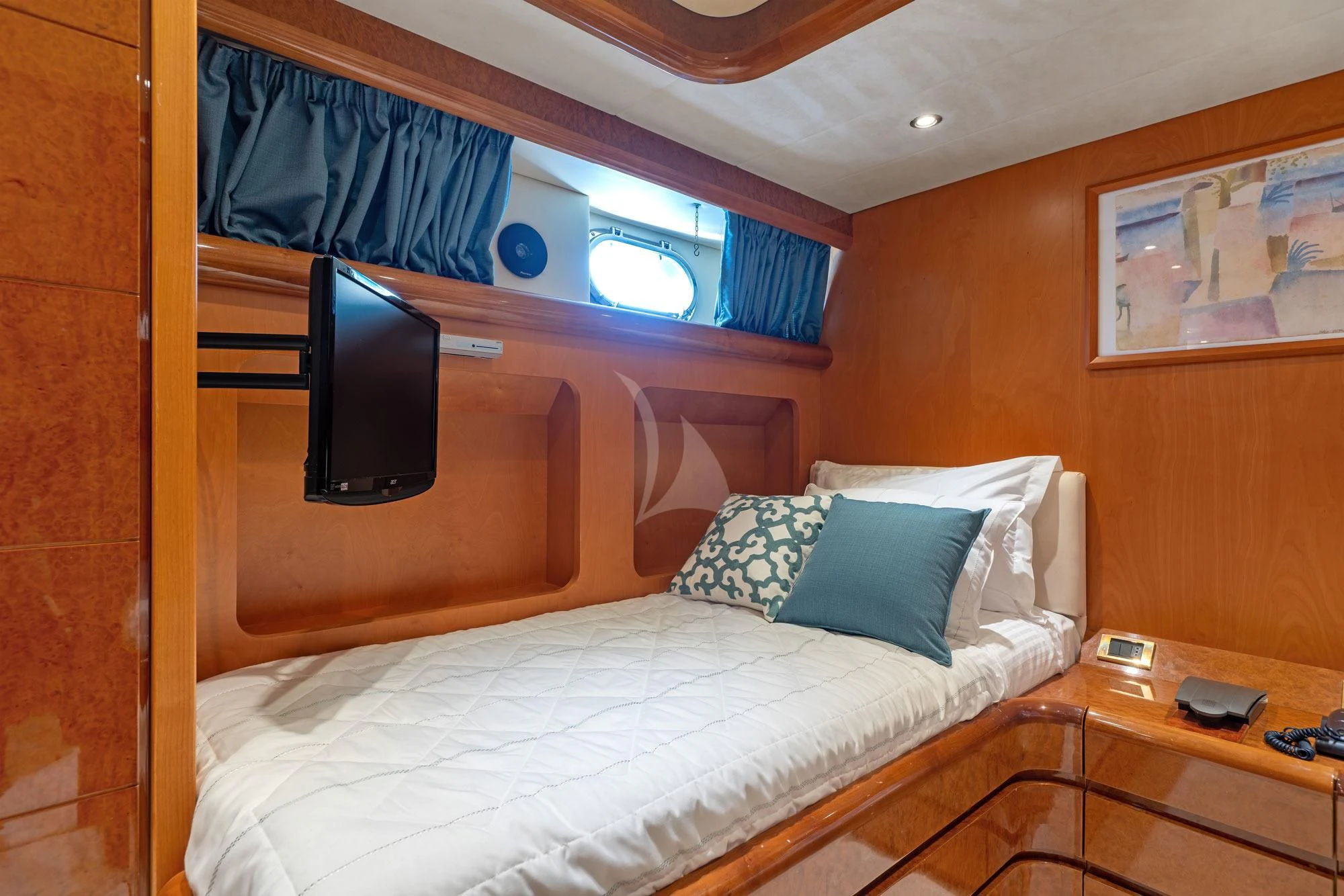a bed with a television on the wall aboard ALANDINI Yacht for Sale