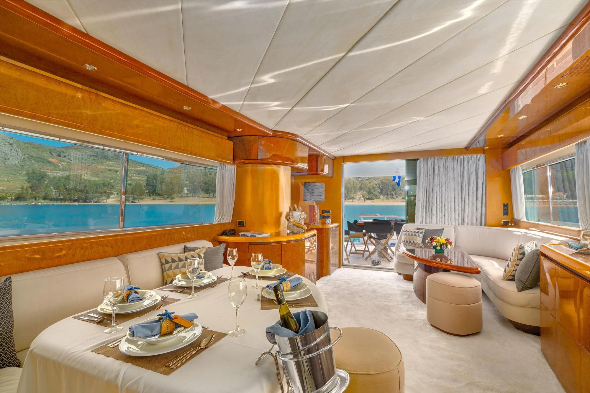 a large living room with a large table and chairs aboard ALANDINI Yacht for Sale