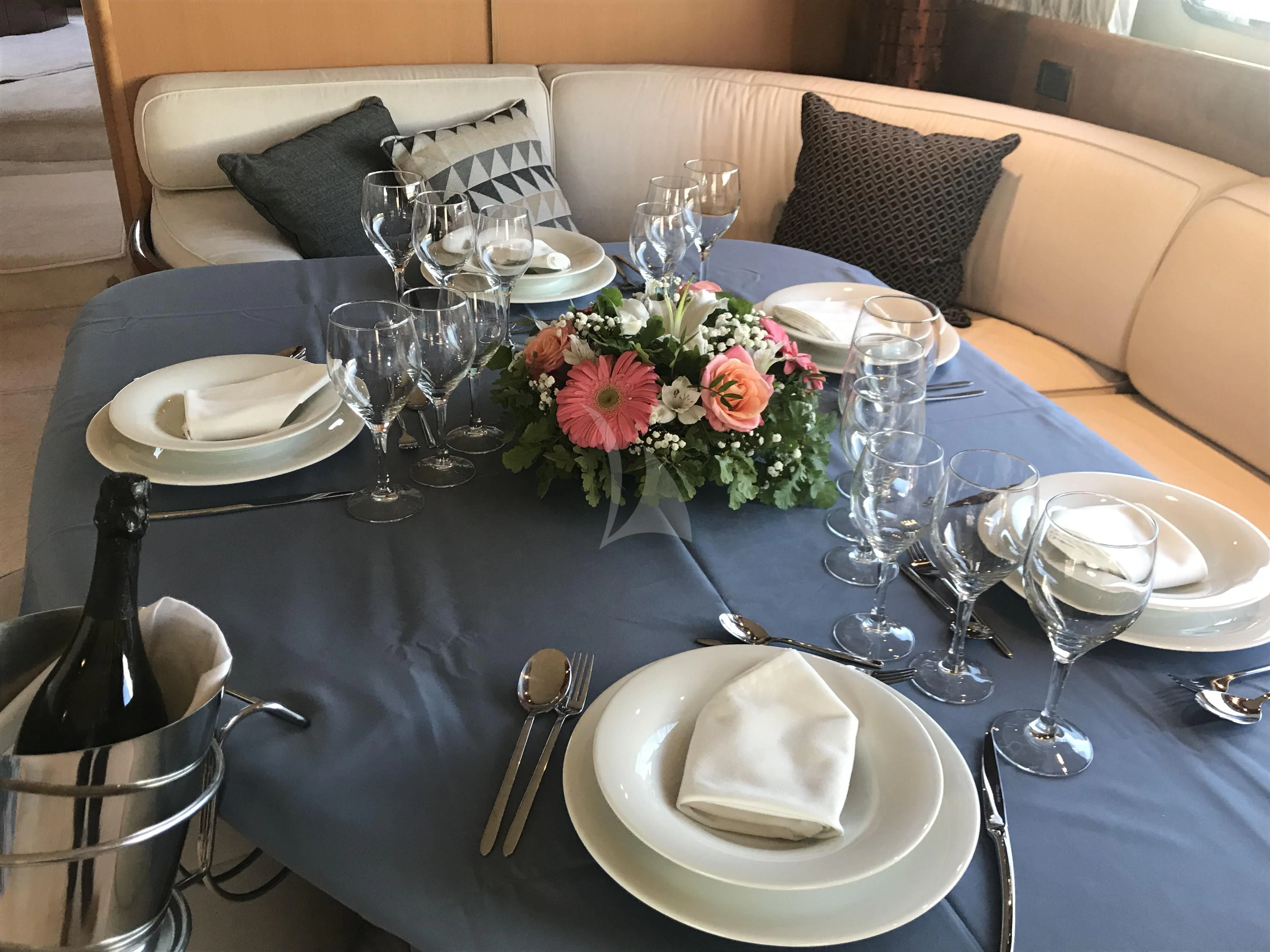 a table with plates and glasses aboard ALANDINI Yacht for Sale