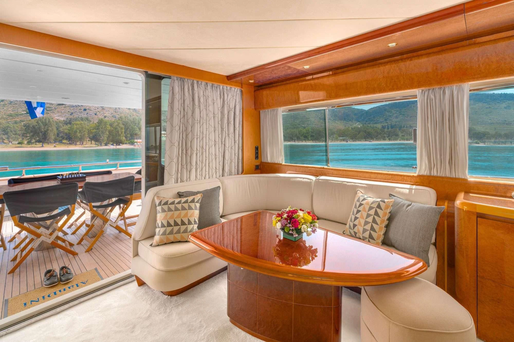 a living room with a table and chairs aboard ALANDINI Yacht for Sale