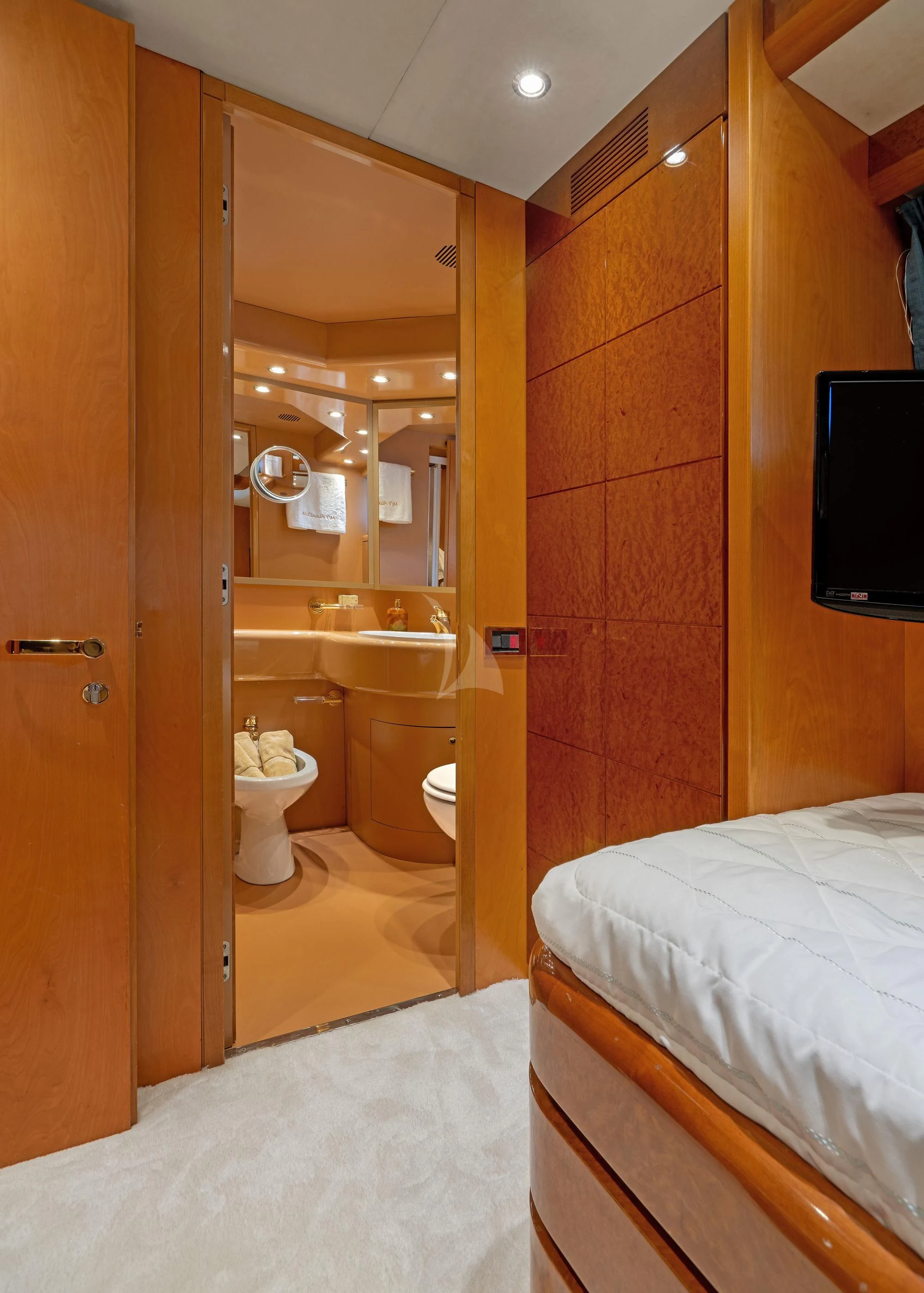 a bathroom with a bed and a tv on the wall aboard ALANDINI Yacht for Sale