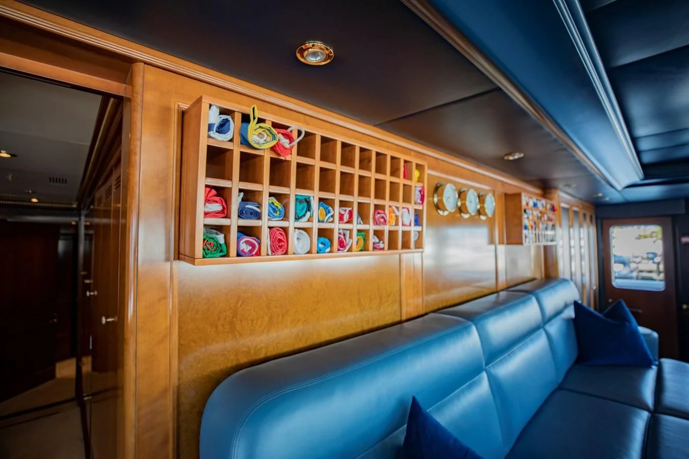 a room with a couch and a window with art on the wall aboard NEXT CHAPTER Yacht for Sale