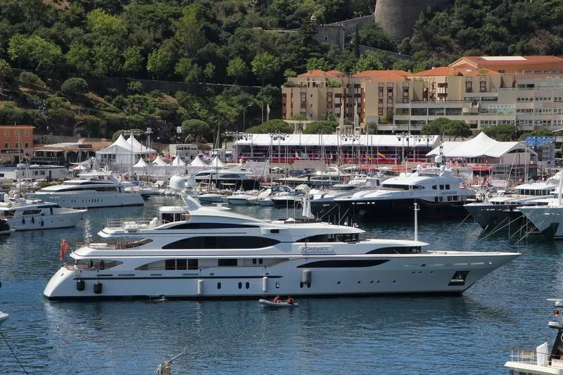 a large white yacht in a harbor aboard NEXT CHAPTER Yacht for Sale