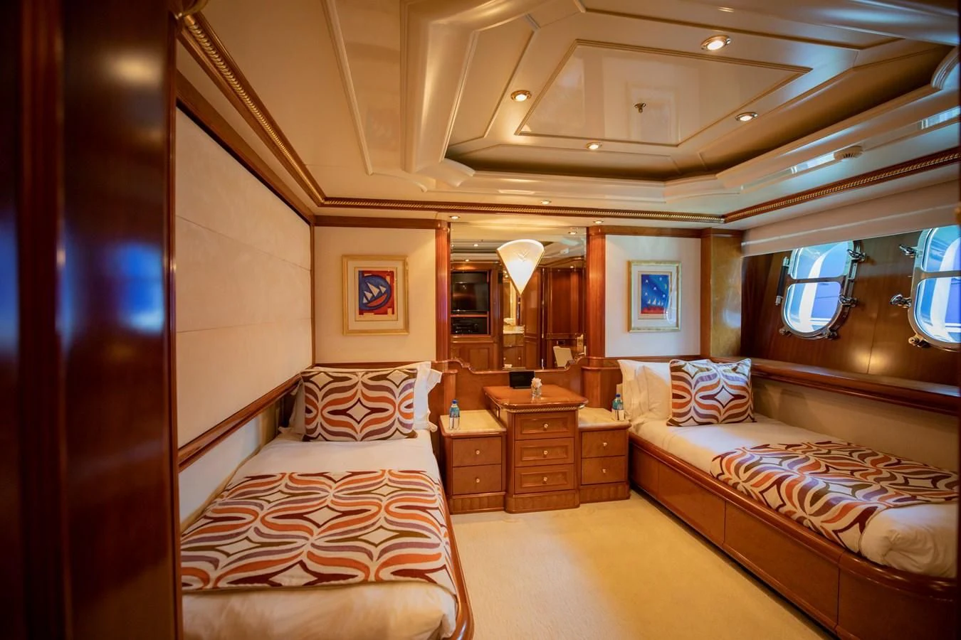 a room with a bed and a mirror aboard NEXT CHAPTER Yacht for Sale
