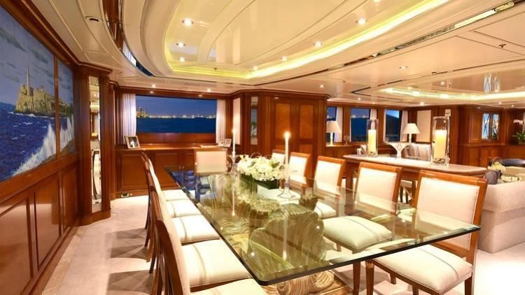 a room with a table chairs and a large window aboard NEXT CHAPTER Yacht for Sale