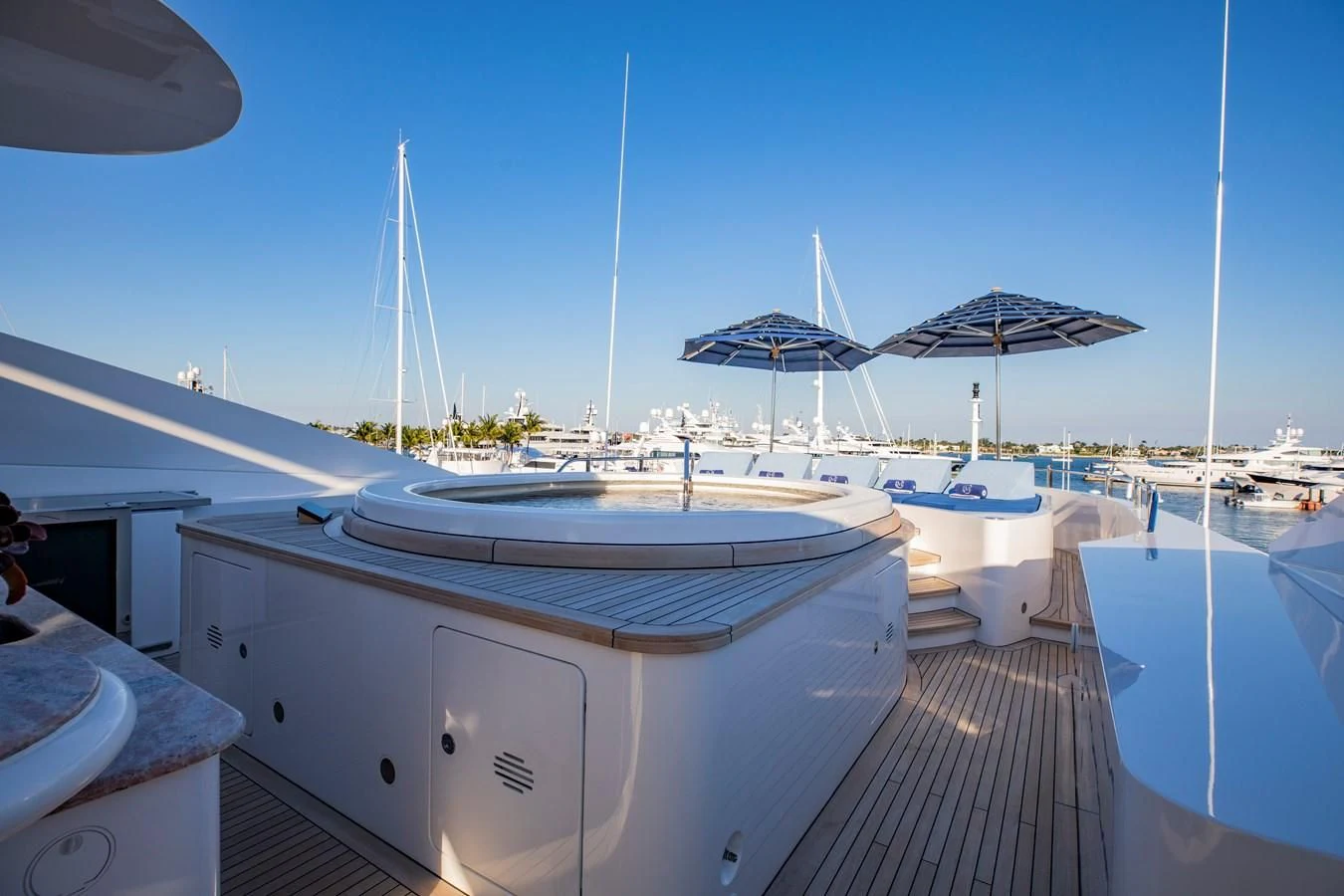 a boat dock with umbrellas aboard NEXT CHAPTER Yacht for Sale